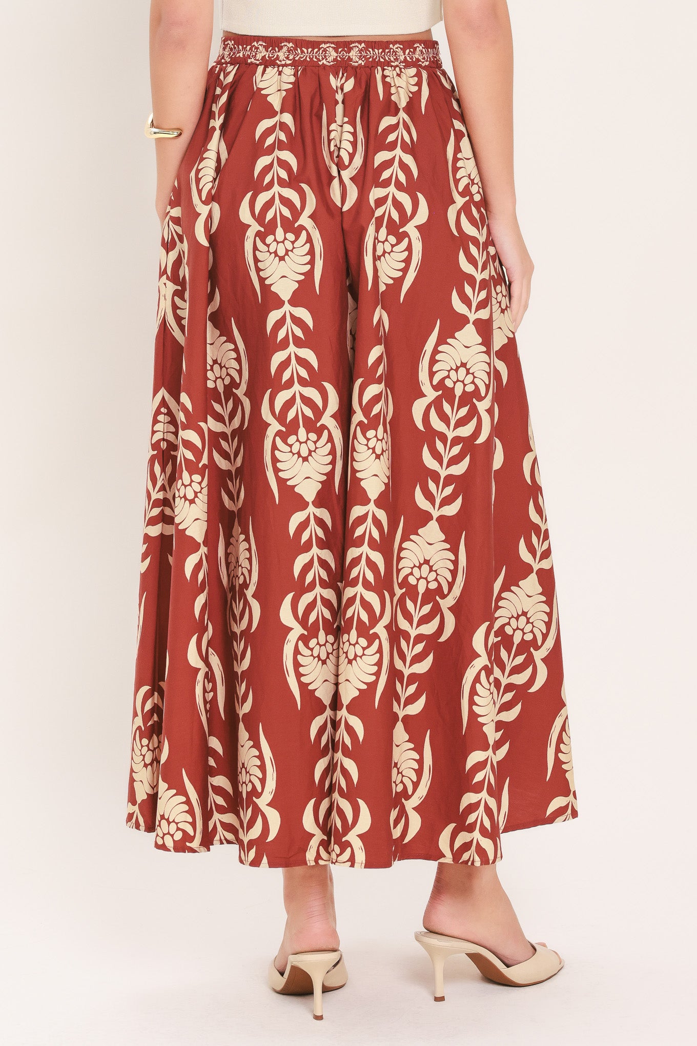 Woman wearing a burgundy ankle skirt with beige floral pattern | Flying Tomato