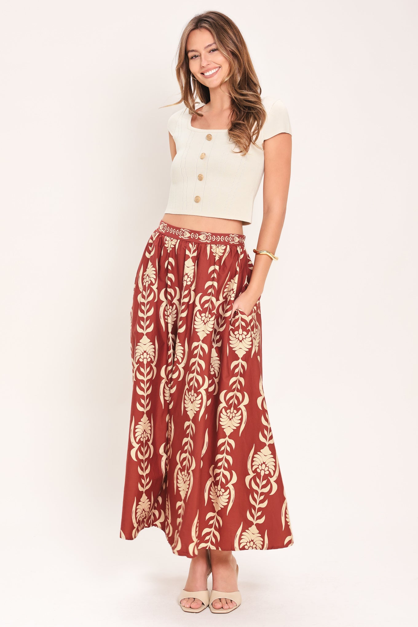 Woman wearing a burgundy ankle skirt with beige floral pattern | Flying Tomato
