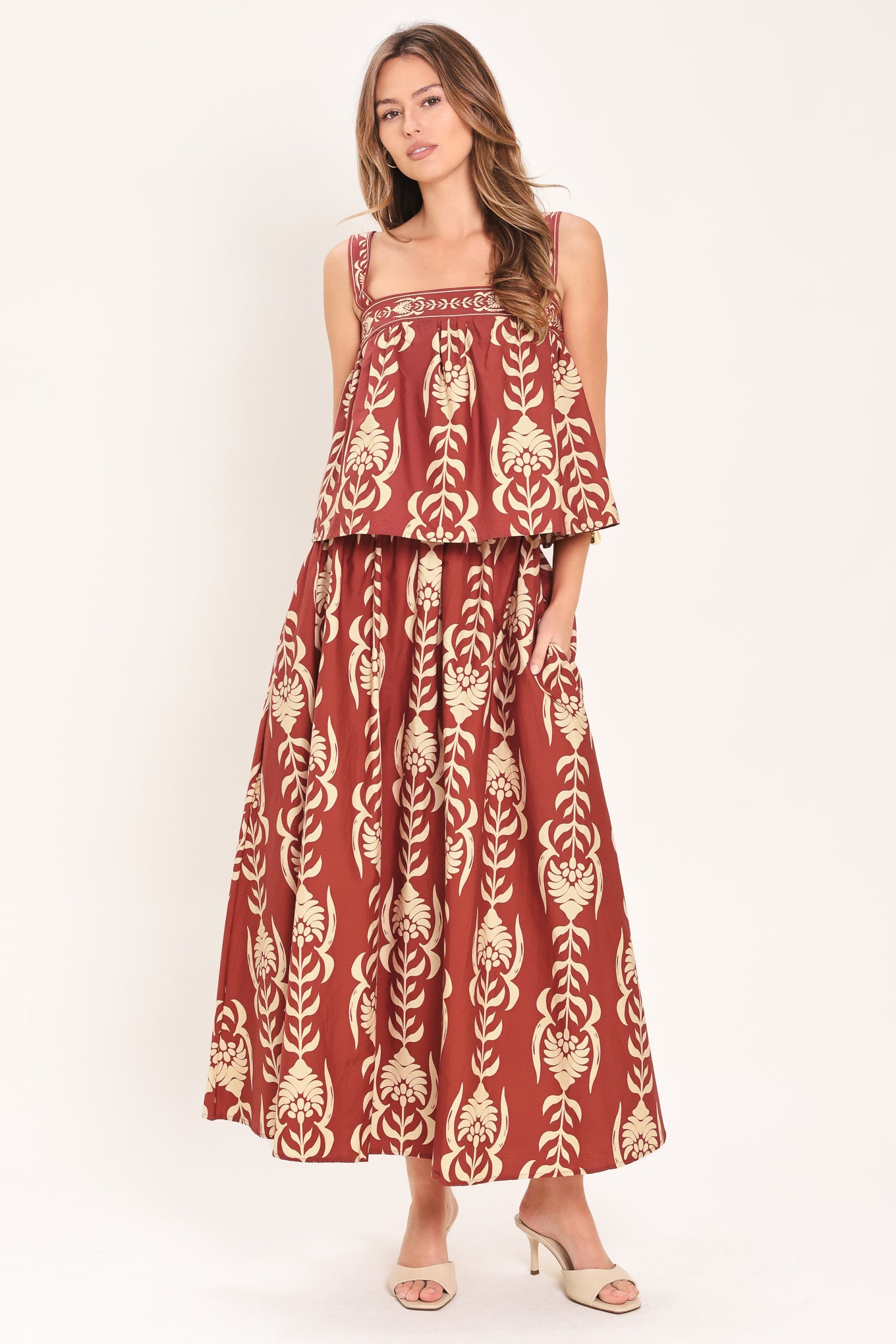 Woman wearing a burgundy ankle skirt with beige floral pattern | Flying Tomato