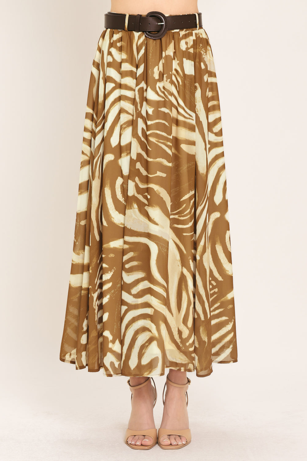 Woman wearing a mocha and taupe zebra print midi skirt with a belt | Flying Tomato