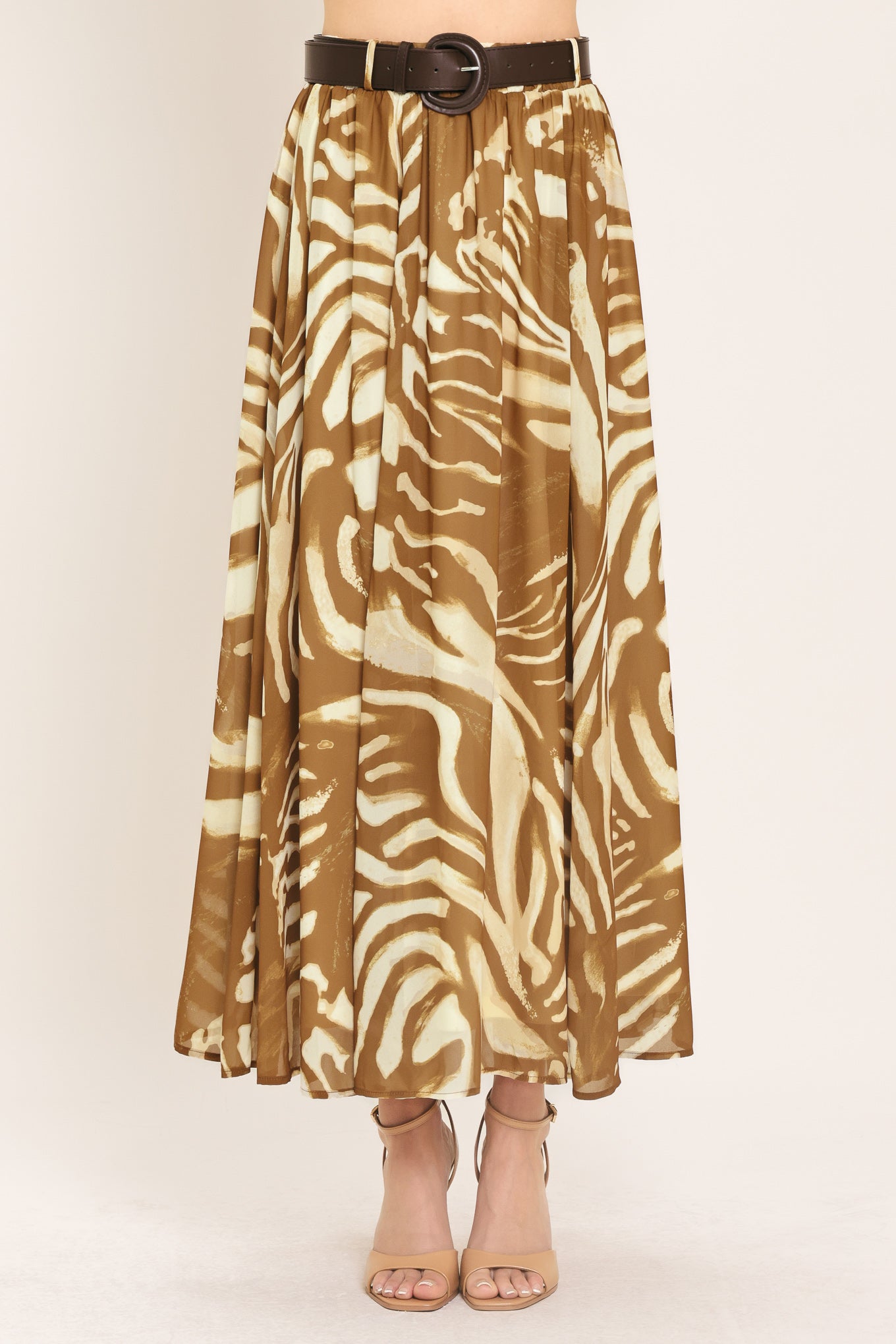 Woman wearing a mocha and taupe zebra print midi skirt with a belt | Flying Tomato