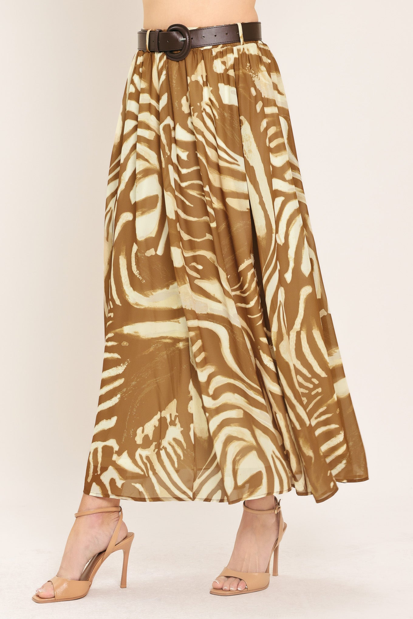 Woman wearing a mocha and taupe zebra print midi skirt with a belt | Flying Tomato