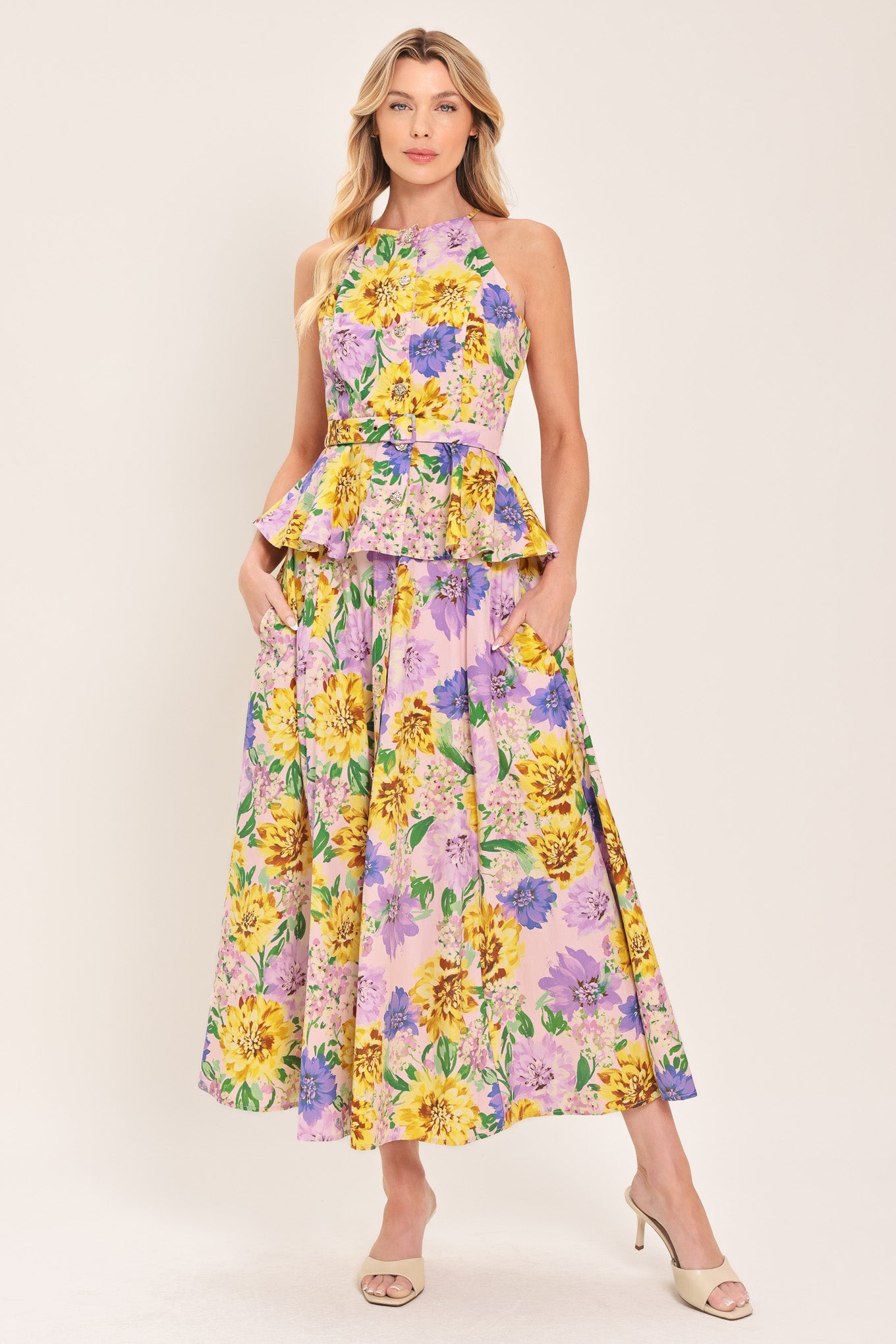 Woman wearing a yellow and purple floral patterned full midi skirt with front button detail and smocked back waistband | Flying Tomato