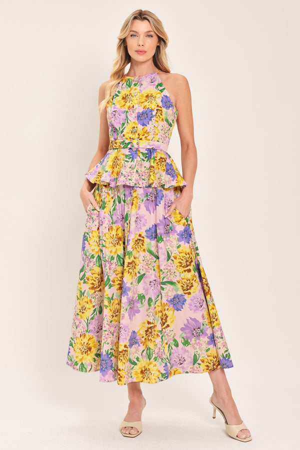 Woman wearing a yellow and purple floral patterned full midi skirt with front button detail and smocked back waistband | Flying Tomato