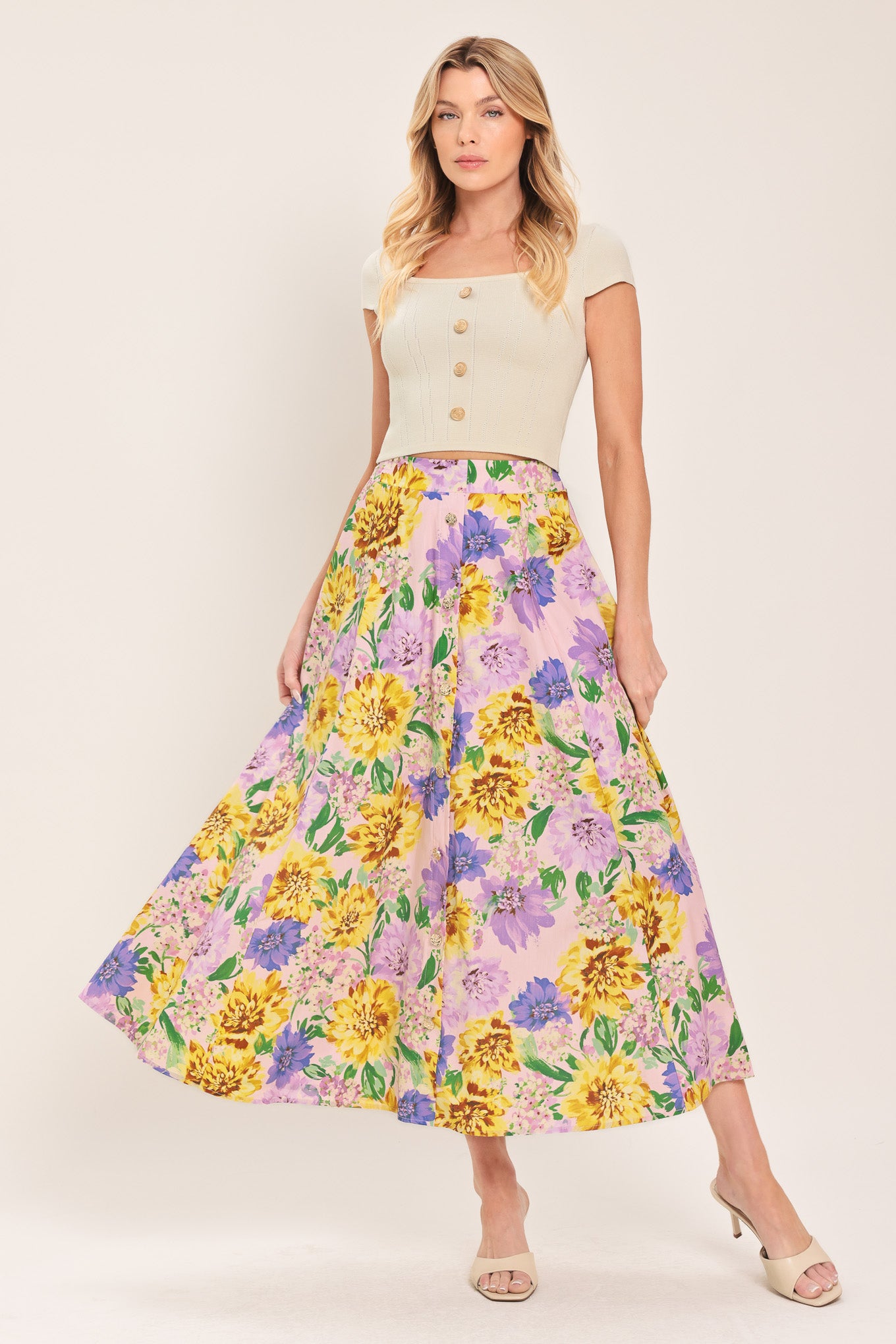 Woman wearing a yellow and purple floral patterned full midi skirt with front button detail and smocked back waistband | Flying Tomato