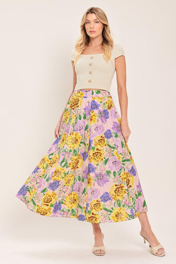 Woman wearing a yellow and purple floral patterned full midi skirt with front button detail and smocked back waistband | Flying Tomato