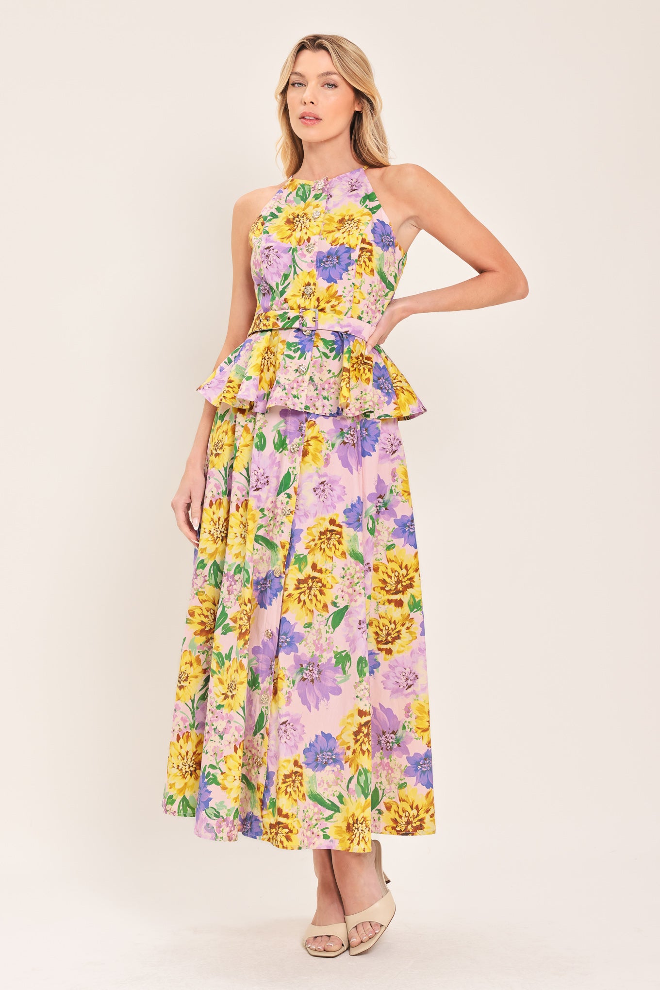 Woman wearing a yellow and purple floral patterned full midi skirt with front button detail and smocked back waistband | Flying Tomato
