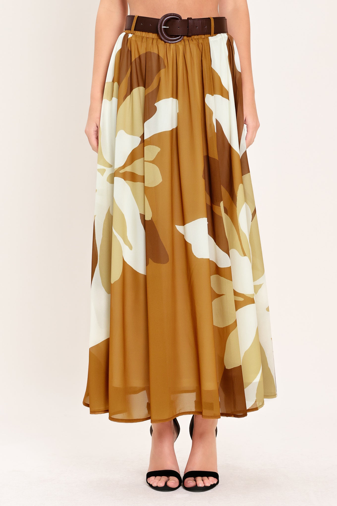 Woman wearing a long, multi color camel and brown and ivory floral-patterned midi skirt with elastic waist and contrasting belt | Flying Tomato