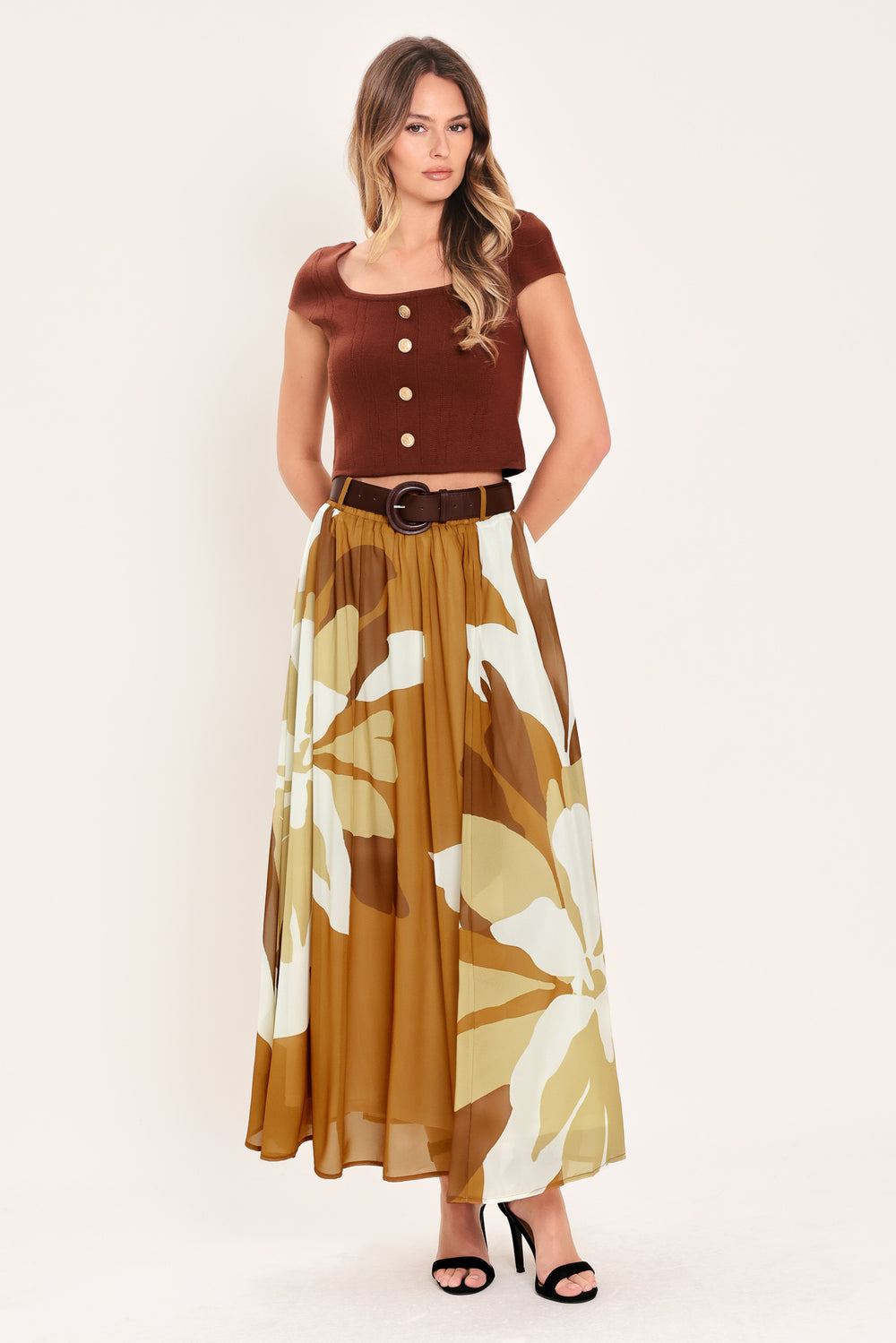 Woman wearing a long, multi color camel and brown and ivory floral-patterned midi skirt with elastic waist and contrasting belt | Flying Tomato