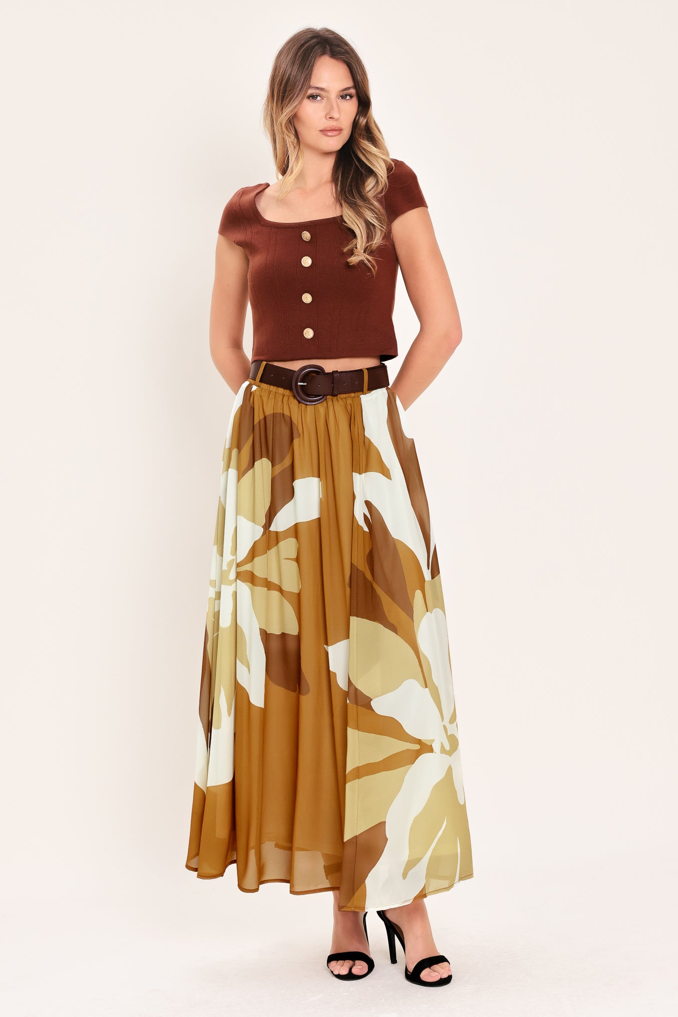 Woman wearing a long, multi color camel and brown and ivory floral-patterned midi skirt with elastic waist and contrasting belt | Flying Tomato