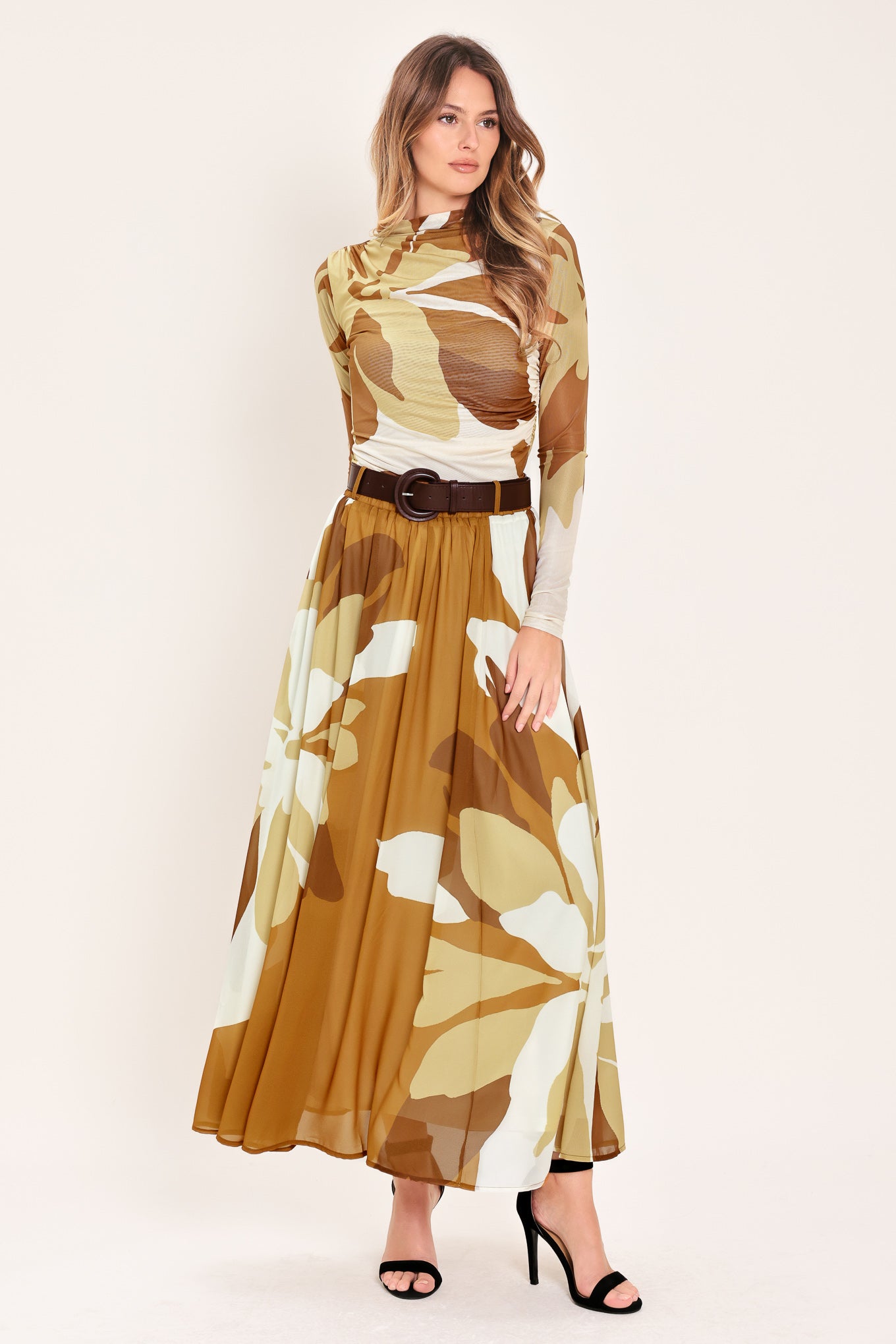 Woman wearing a long, multi color camel and brown and ivory floral-patterned midi skirt with elastic waist and contrasting belt | Flying Tomato