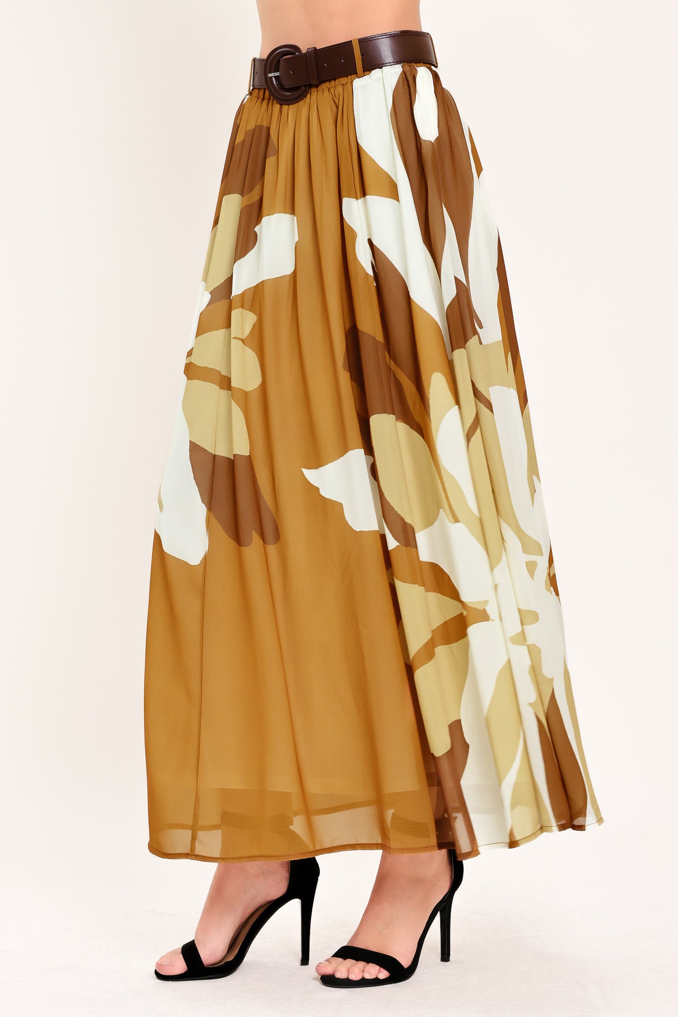 Woman wearing a long, multi color camel and brown and ivory floral-patterned midi skirt with elastic waist and contrasting belt | Flying Tomato