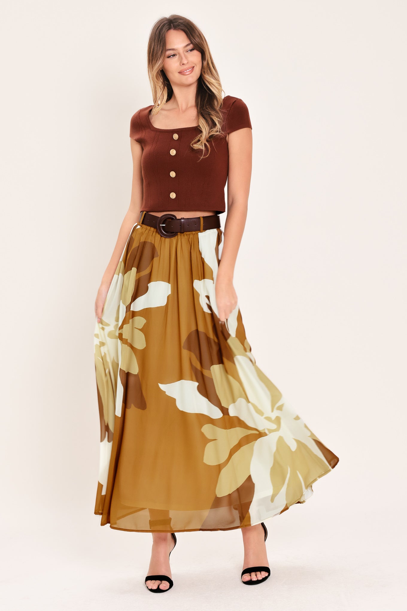 Woman wearing a long, multi color camel and brown and ivory floral-patterned midi skirt with elastic waist and contrasting belt | Flying Tomato