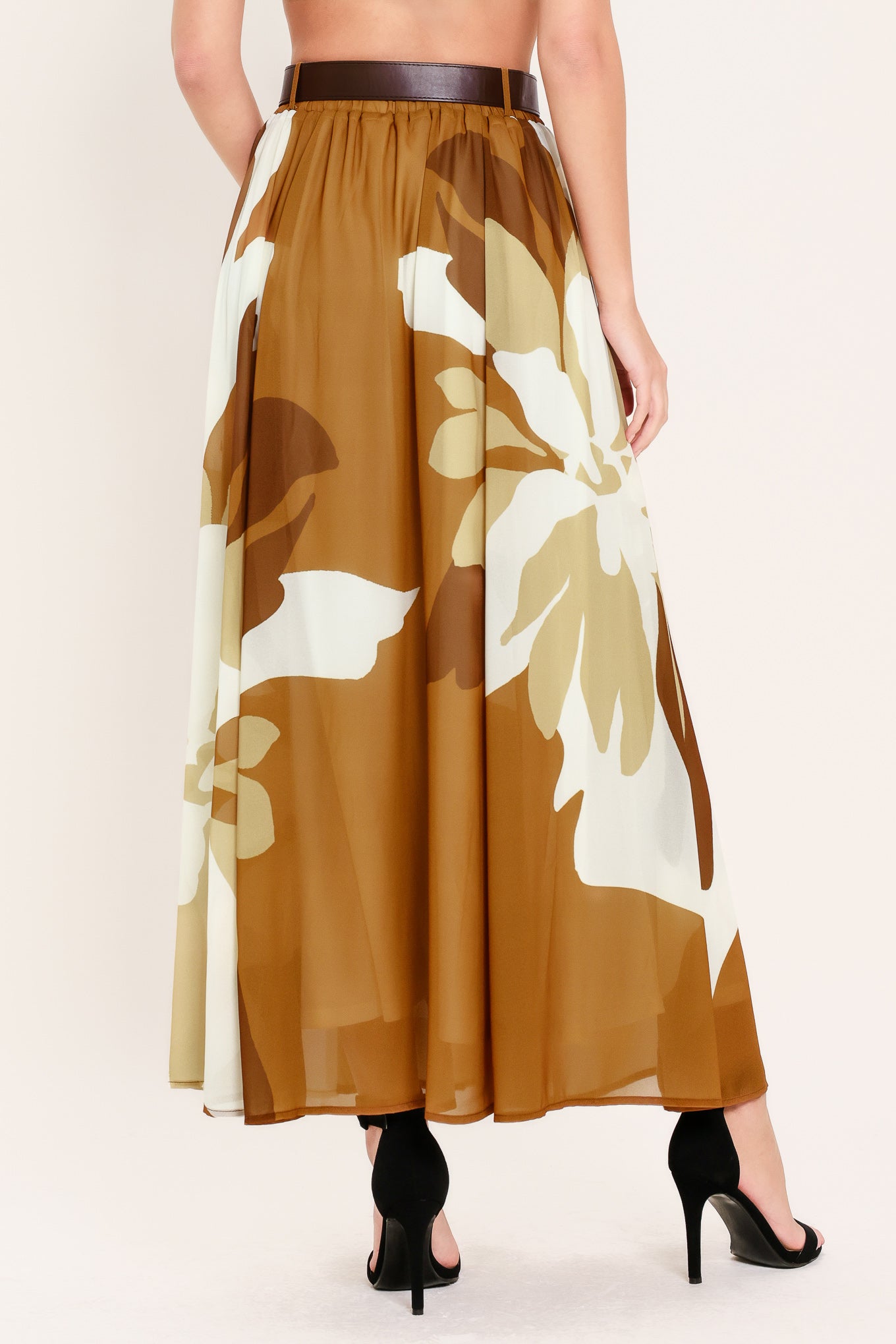 Woman wearing a long, multi color camel and brown and ivory floral-patterned midi skirt with elastic waist and contrasting belt | Flying Tomato