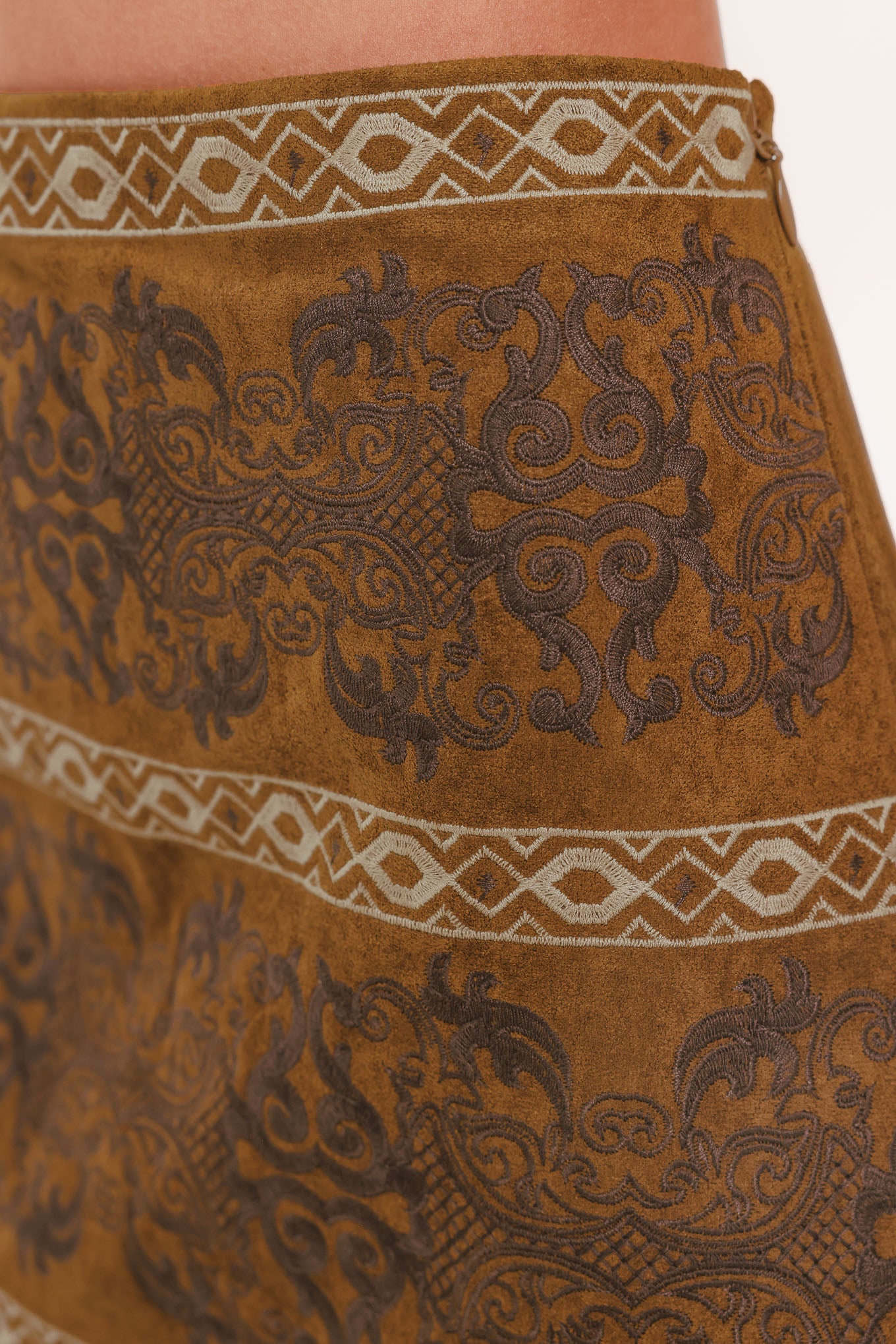 A camel mini skirt with a dark brown damask pattern and cream geometric borders | Flying Tomato