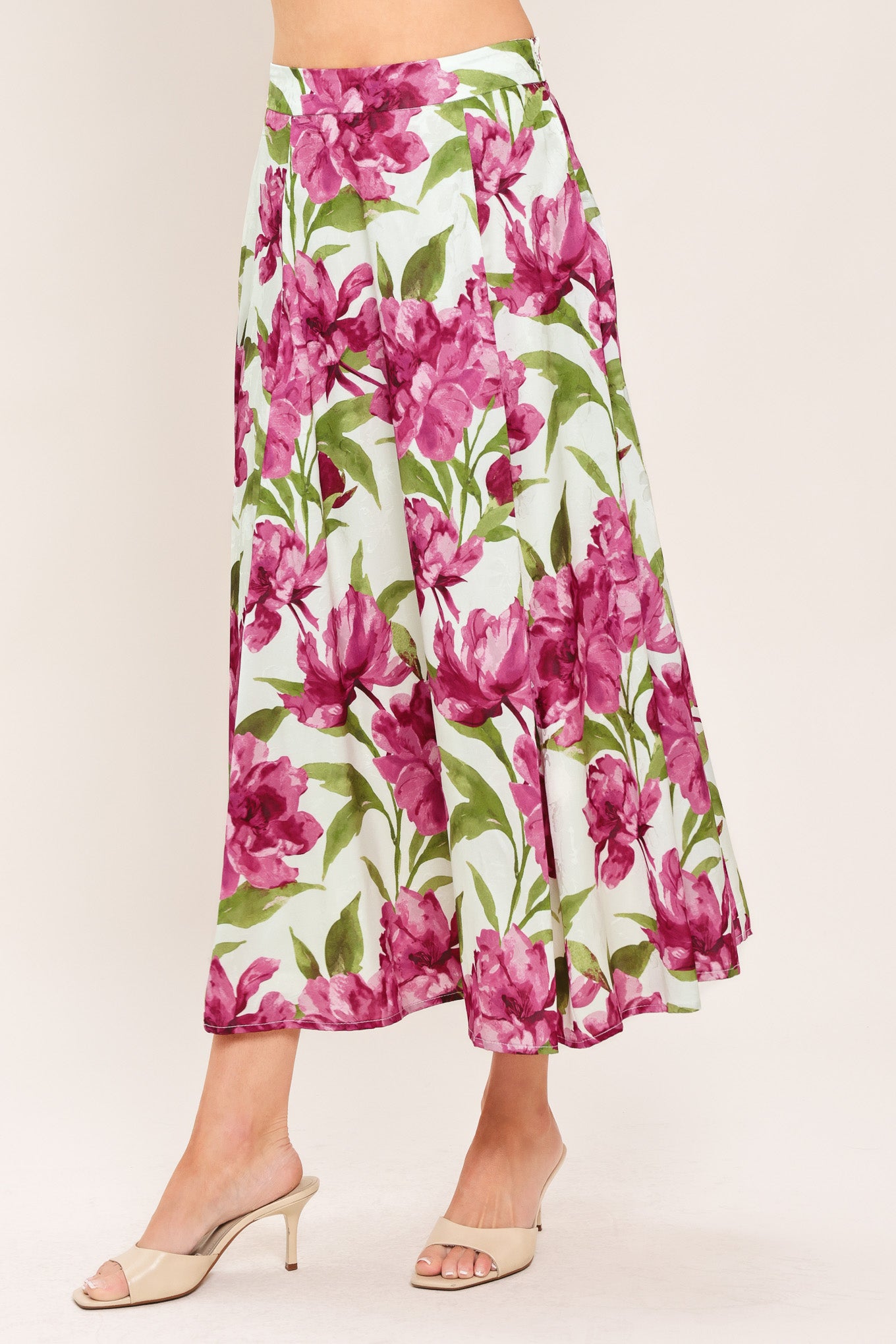 A high-waisted, A-line midi skirt with a vibrant pink and green floral print on a white background | Flying Tomato