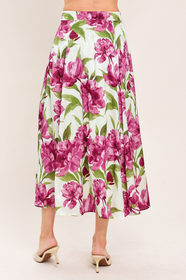 A high-waisted, A-line midi skirt with a vibrant pink and green floral print on a white background | Flying Tomato