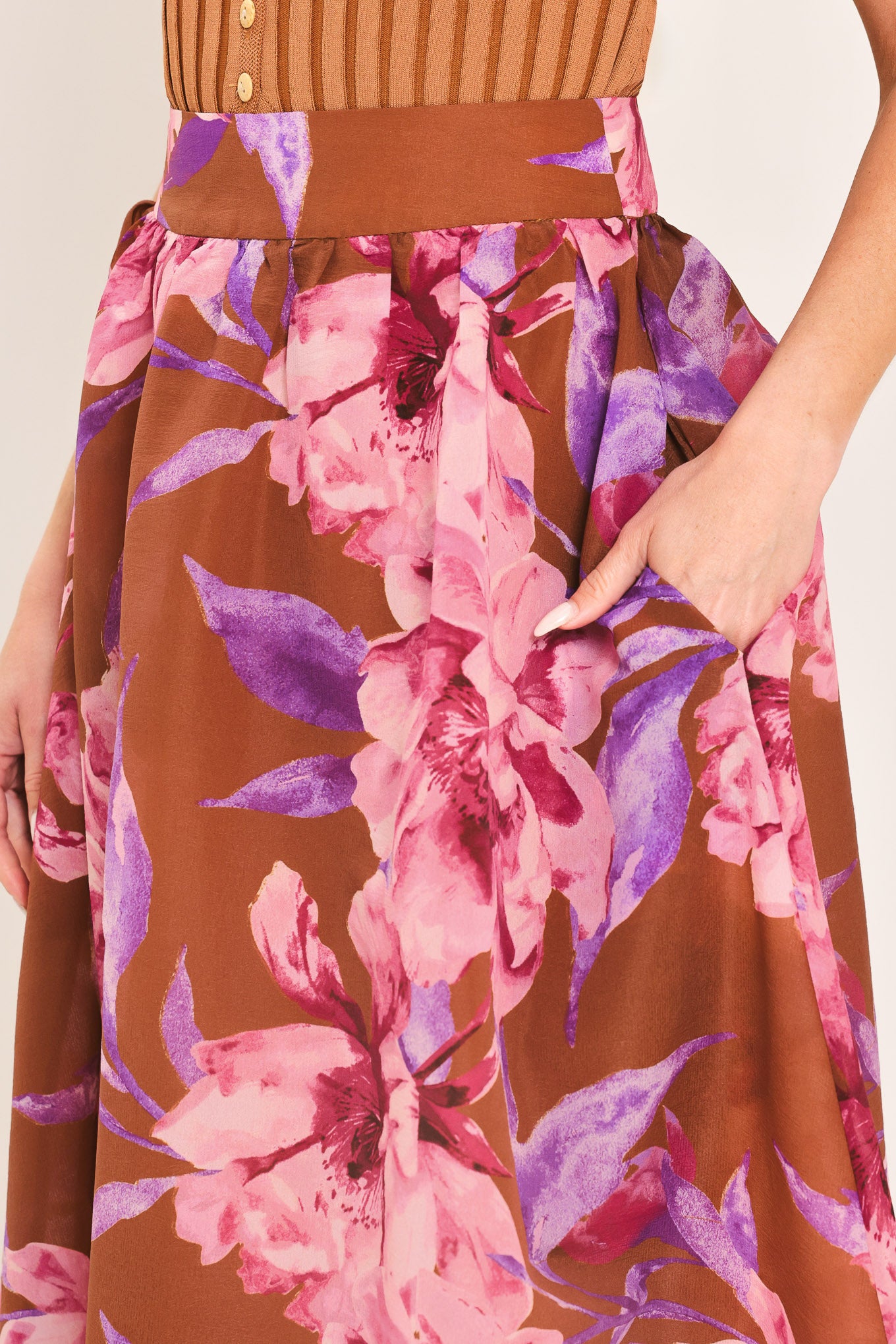 Woman wearing a brown floral maxi skirt with pink and purple flowers | Flying Tomato