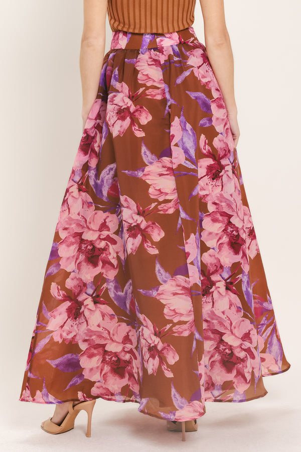 Woman wearing a brown floral maxi skirt with pink and purple flowers | Flying Tomato