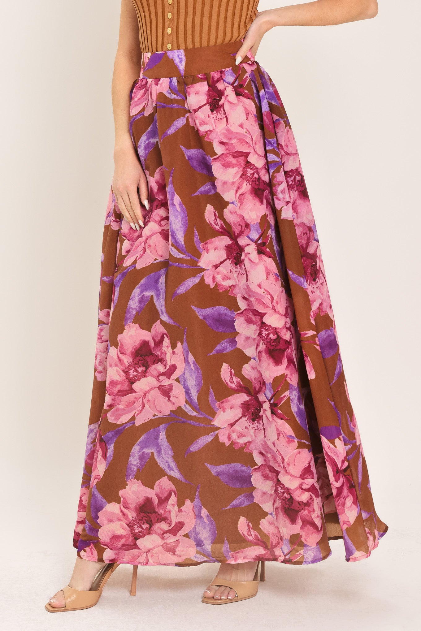 Woman wearing a brown floral maxi skirt with pink and purple flowers | Flying Tomato