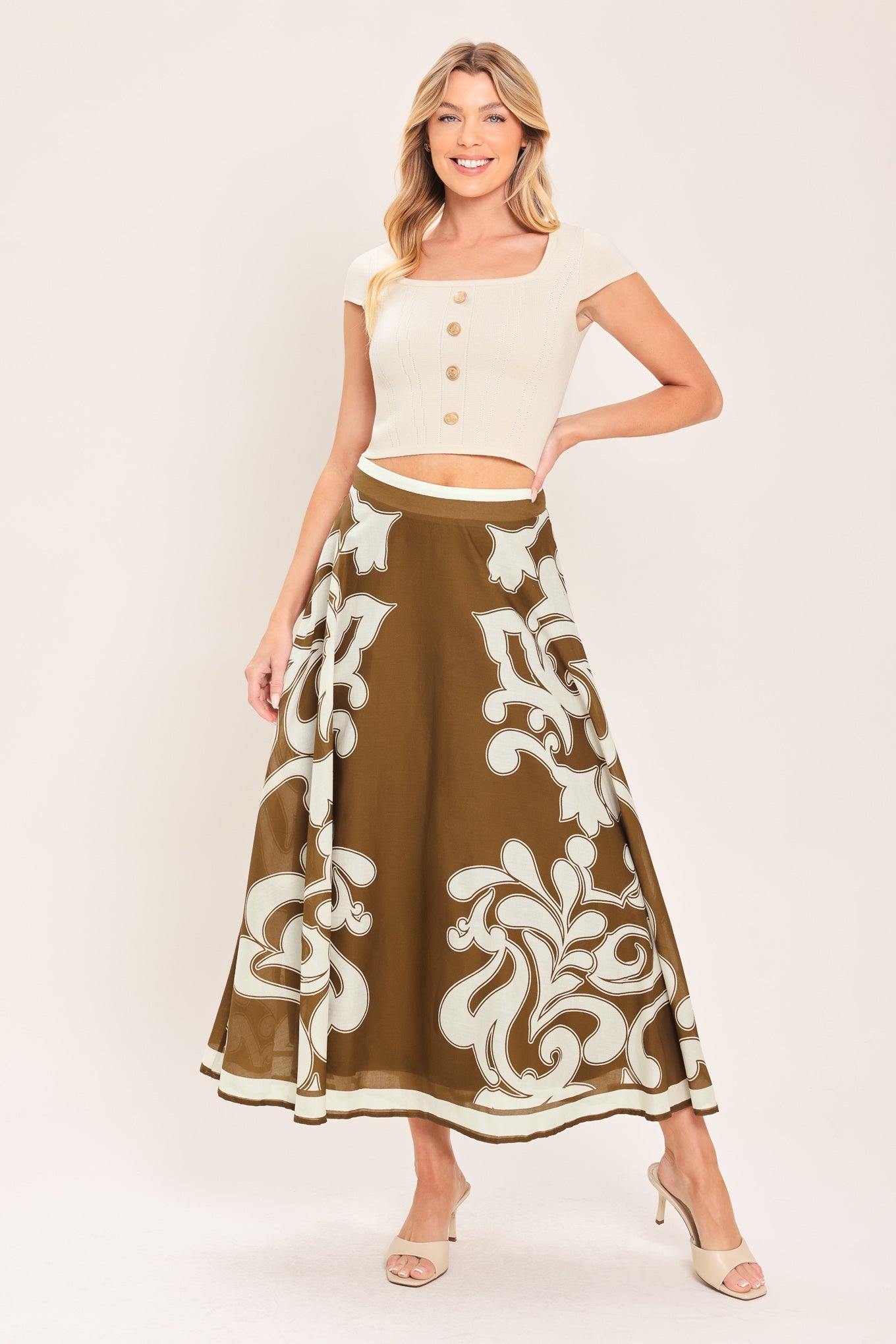 A woman wearing a brown midi skirt with a large white baroque pattern | Flying Tomato