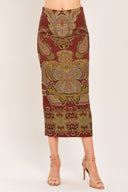 A woman wearing a midi skirt with an ornate paisley pattern in rust red, gold, and olive green | Flying Tomato