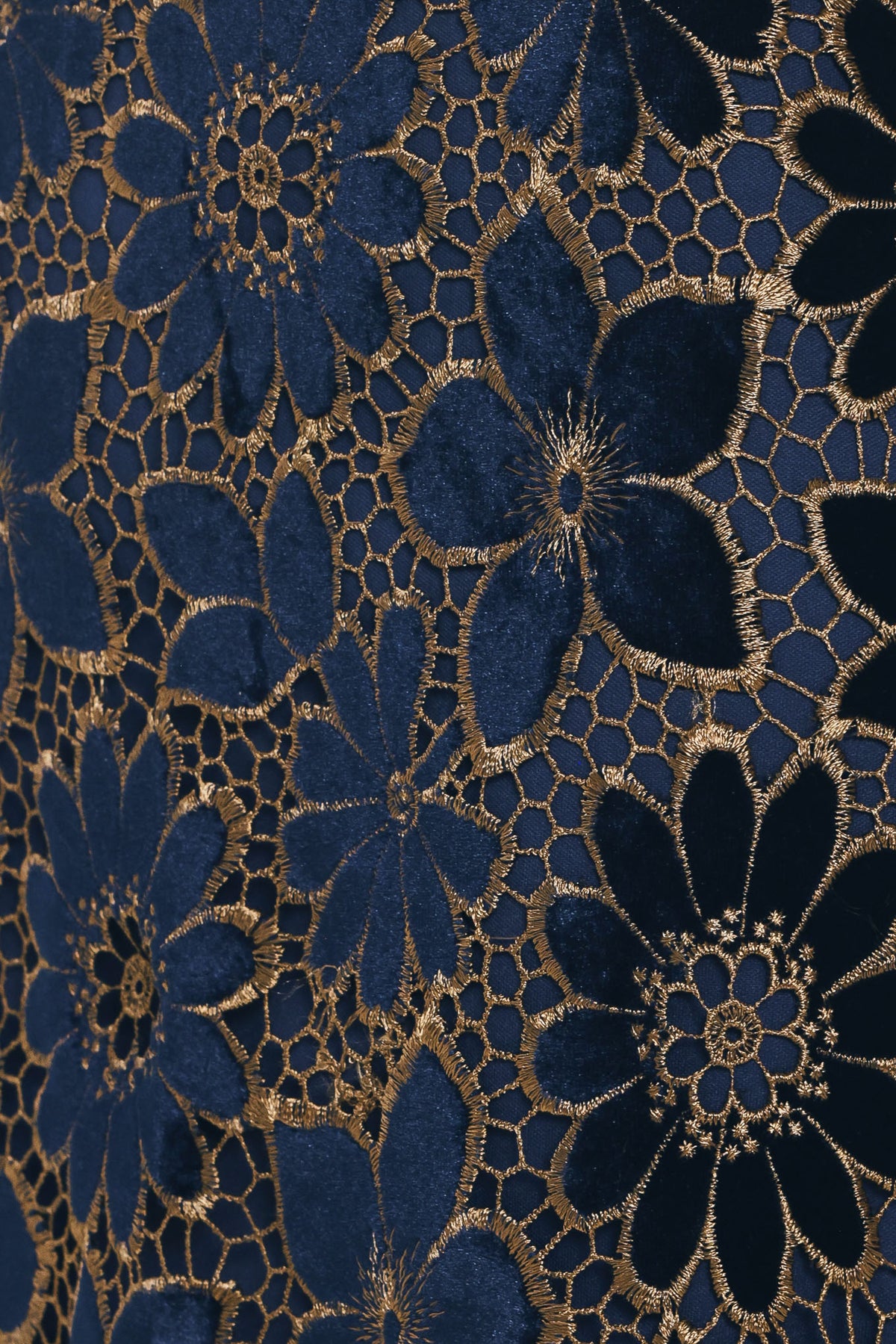 Woman wearing a navy blue velvet high-waisted mini skirt with gold floral lace over | Flying Tomato