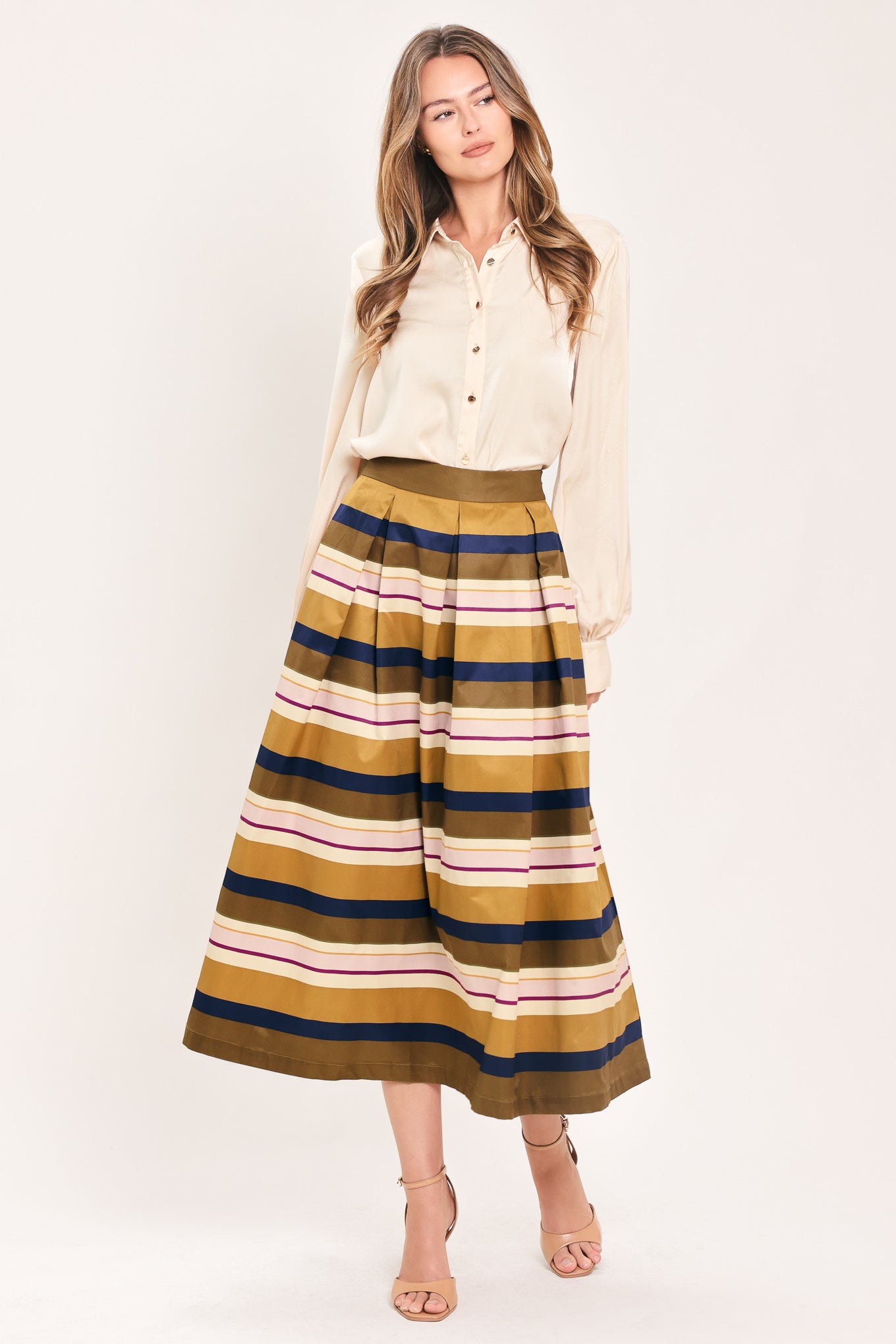 Woman wearing a multicolored beige, mustard yellow, navy blue, and burgundy striped midi skirt with pleats and pockets | Flying Tomato