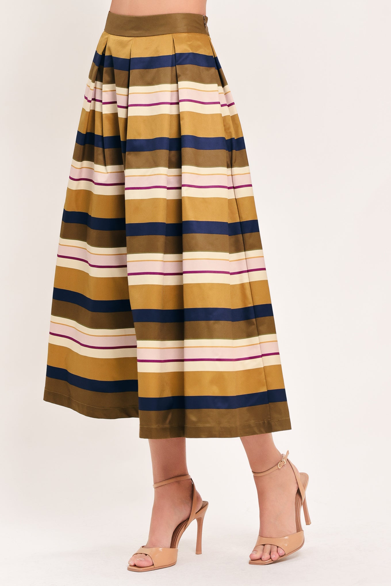 Woman wearing a multicolored beige, mustard yellow, navy blue, and burgundy striped midi skirt with pleats and pockets | Flying Tomato