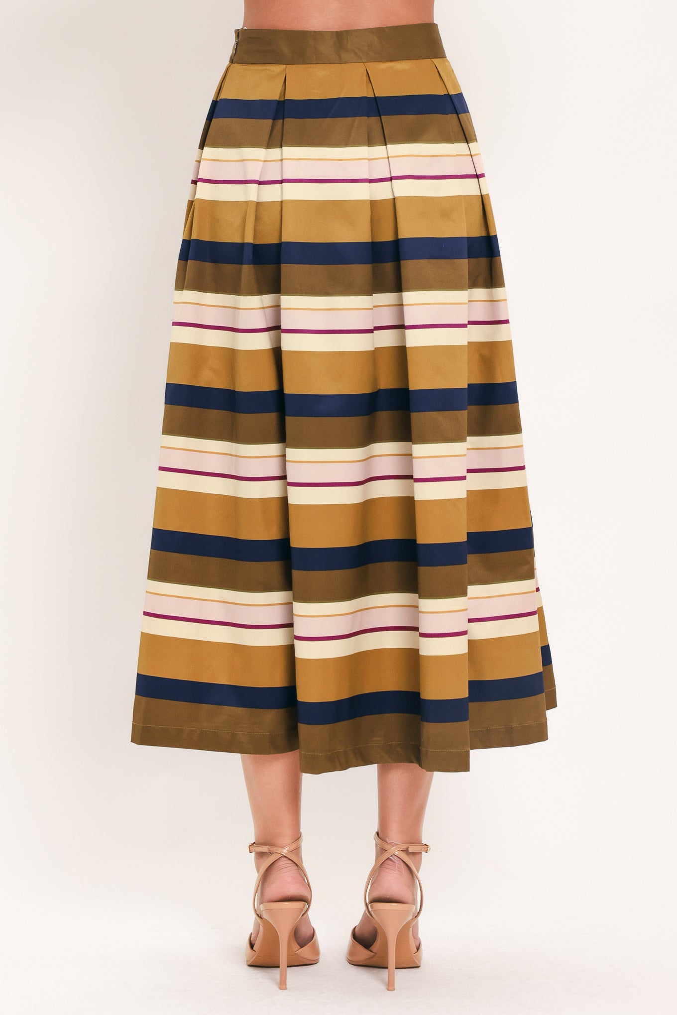 Woman wearing a multicolored beige, mustard yellow, navy blue, and burgundy striped midi skirt with pleats and pockets | Flying Tomato