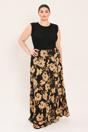 A woman modeling a sleeveless black top paired with a long black skirt featuring a large beige floral print | Plus Curve Flying Tomato