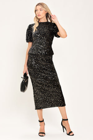 A black sequined midi skirt worn by a model | Flying Tomato
