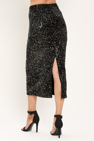 A black sequined midi skirt worn by a model | Flying Tomato