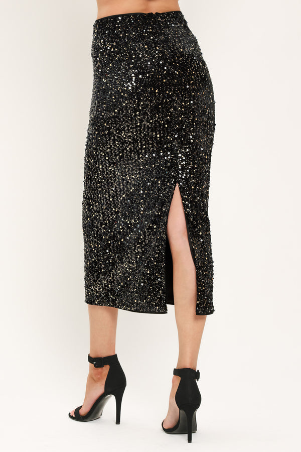 A black sequined midi skirt worn by a model | Flying Tomato