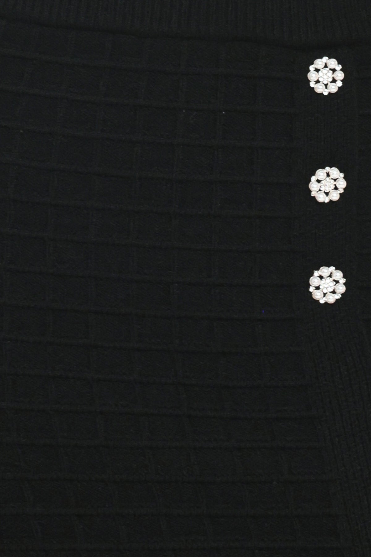 A black textured midi skirt with a front slit and three decorative silver buttons, worn by a model | Flying Tomato