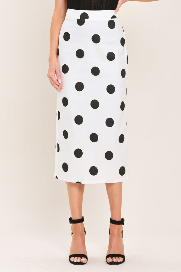 A woman wearing a white midi pencil skirt with large black polka dots | Flying Tomato