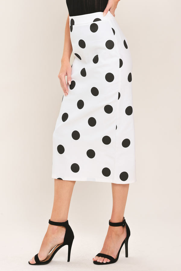 A woman wearing a white midi pencil skirt with large black polka dots | Flying Tomato