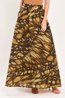 A woman wearing a dark brown maxi skirt with a butterfly-like pattern | Flying Tomato
