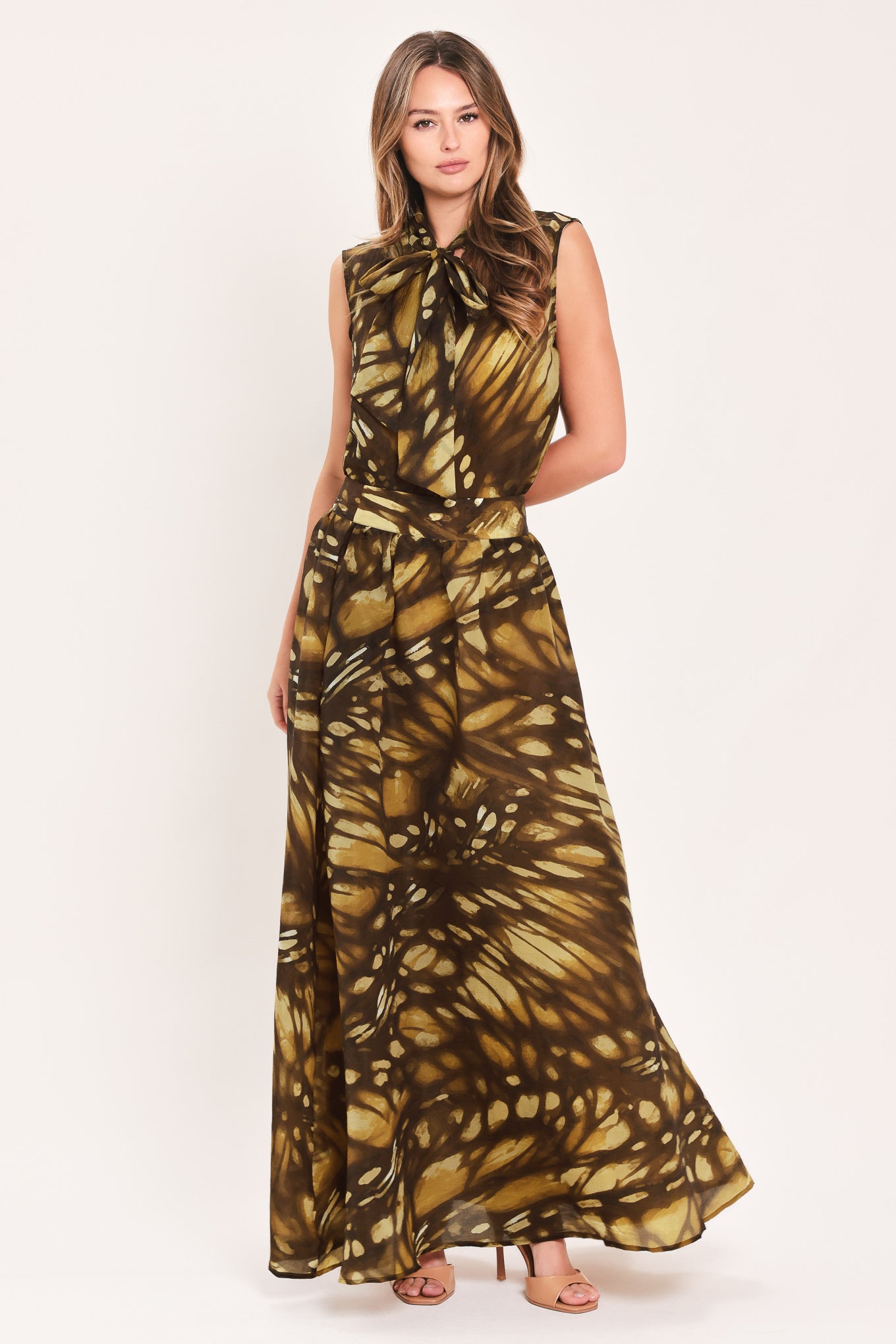 A woman wearing a dark brown maxi skirt with a butterfly-like pattern | Flying Tomato