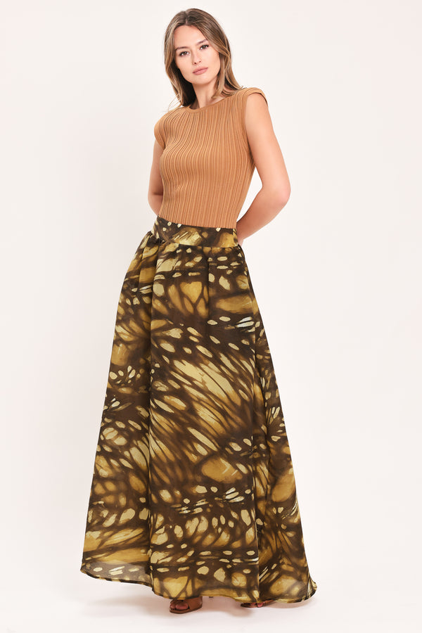 A woman wearing a dark brown maxi skirt with a butterfly-like pattern | Flying Tomato