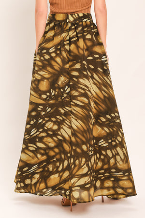 A woman wearing a dark brown maxi skirt with a butterfly-like pattern | Flying Tomato