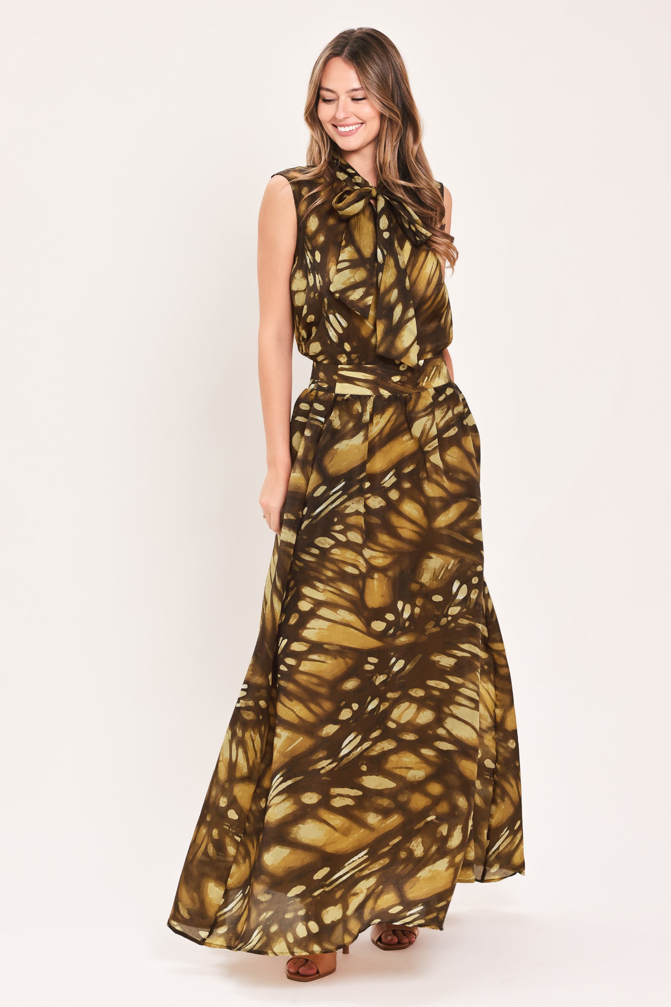 A woman wearing a dark brown maxi skirt with a butterfly-like pattern | Flying Tomato