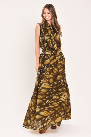 A woman wearing a dark brown maxi skirt with a butterfly-like pattern | Flying Tomato
