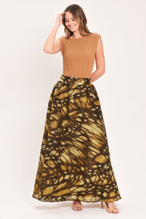 A woman wearing a dark brown maxi skirt with a butterfly-like pattern | Flying Tomato