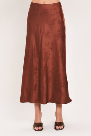 Woman wearing a high waisted jacquard satin midi skirt | Flying Tomato