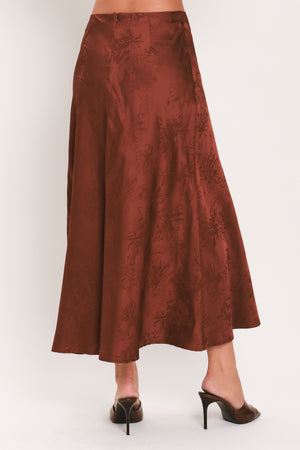 Woman wearing a high waisted jacquard satin midi skirt | Flying Tomato
