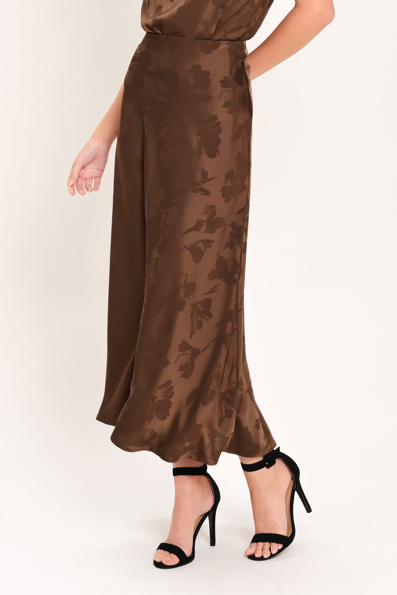 Woman wearing a brown woven jacquard midi skirt with back zipper closure | Flying Tomato