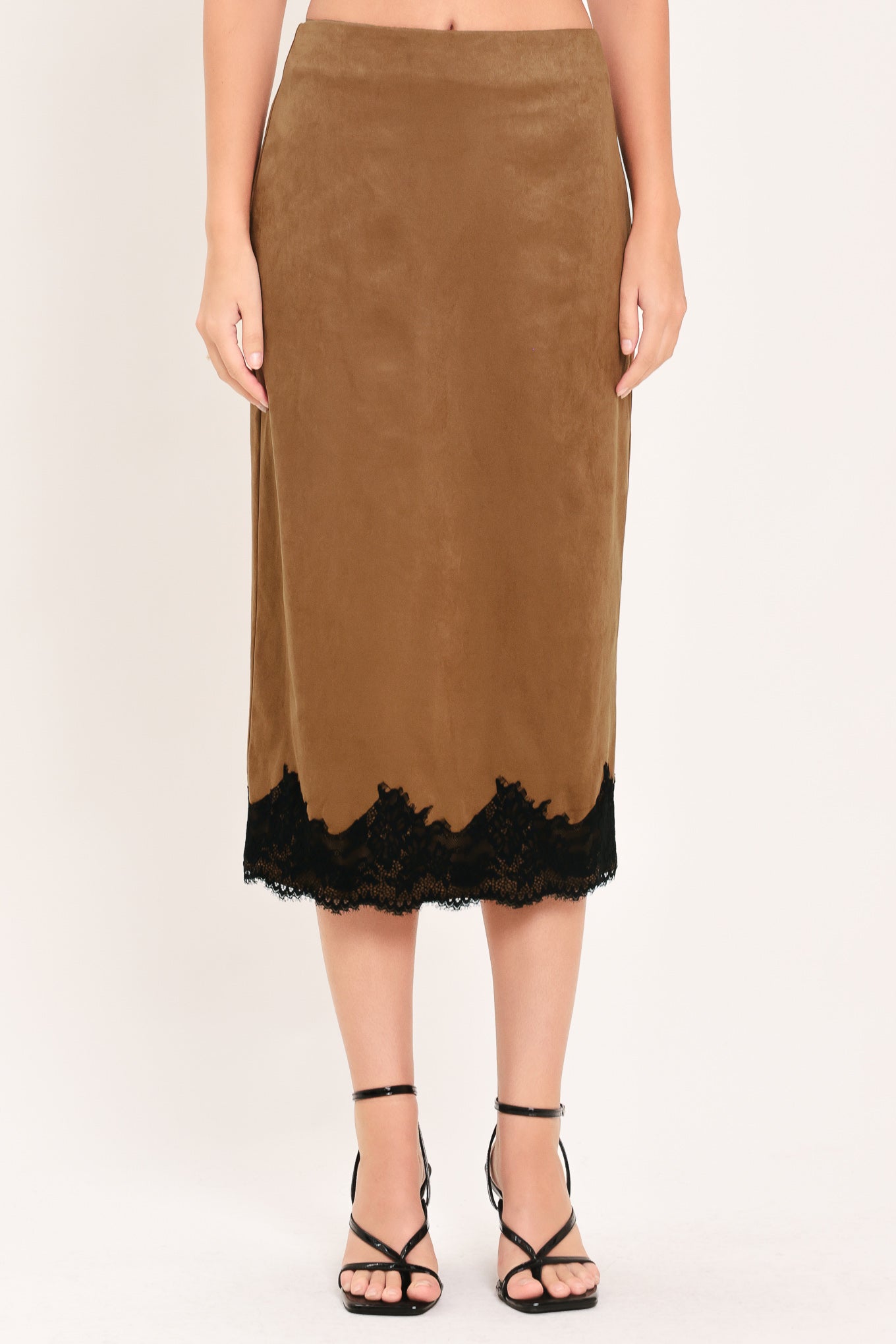 Woman wearing a brown faux suede pencil midi skirt with black lace trim at the bottom| Flying Tomato
