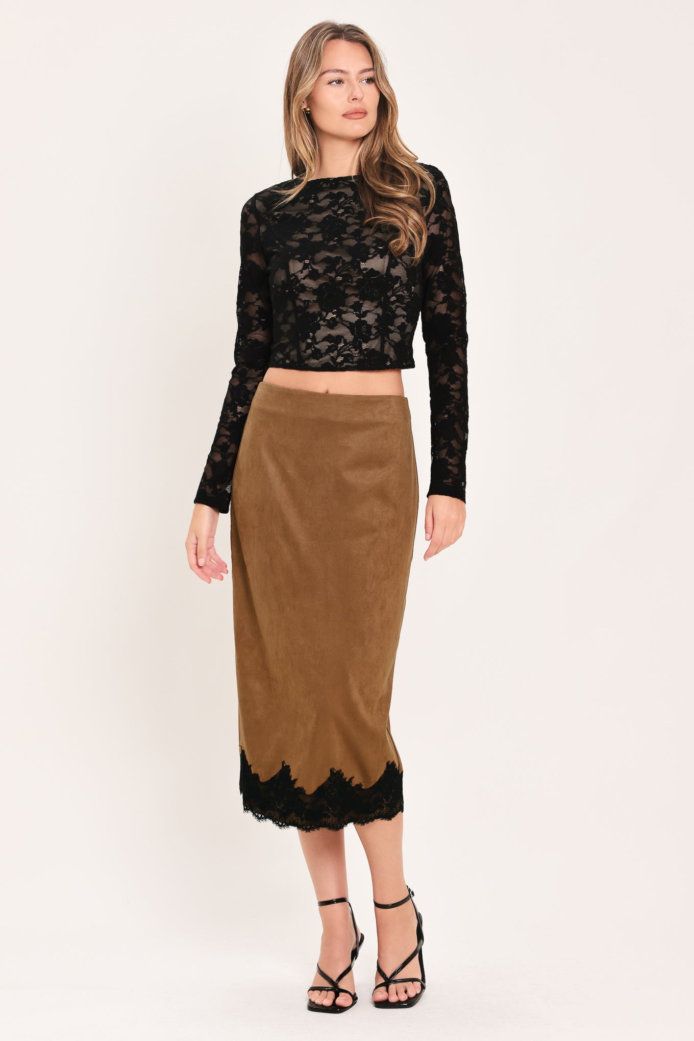 Woman wearing a brown faux suede pencil midi skirt with black lace trim at the bottom| Flying Tomato