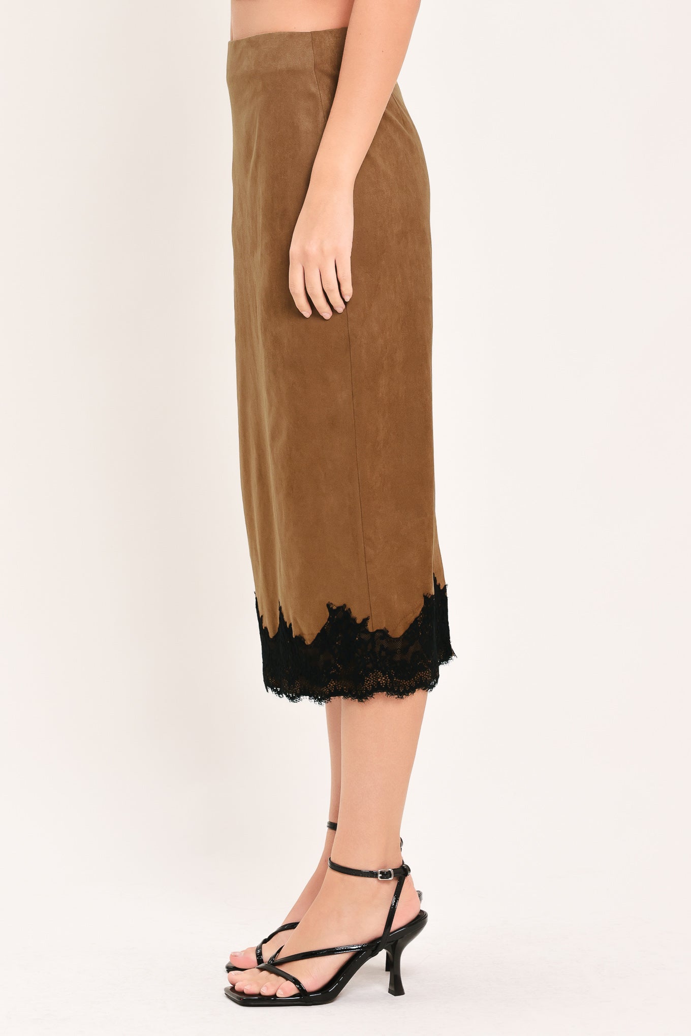 Woman wearing a brown faux suede pencil midi skirt with black lace trim at the bottom| Flying Tomato